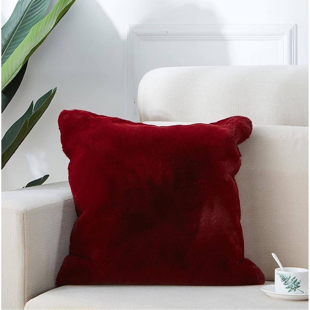 Two red faux fur accent pillows
